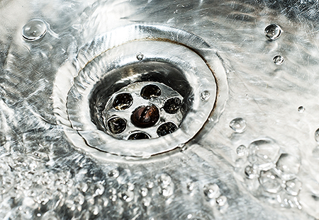 Water flowing down metal drain